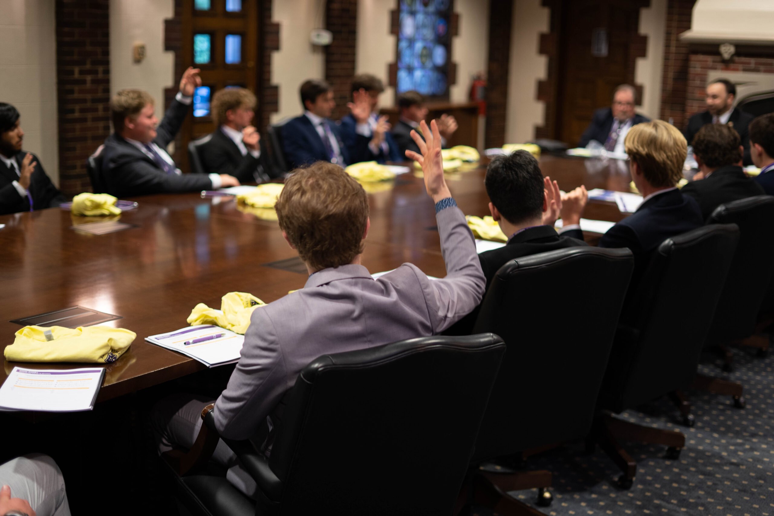 SAE brothers sitting at a conference table at the SAE 85th National Leadership Conference