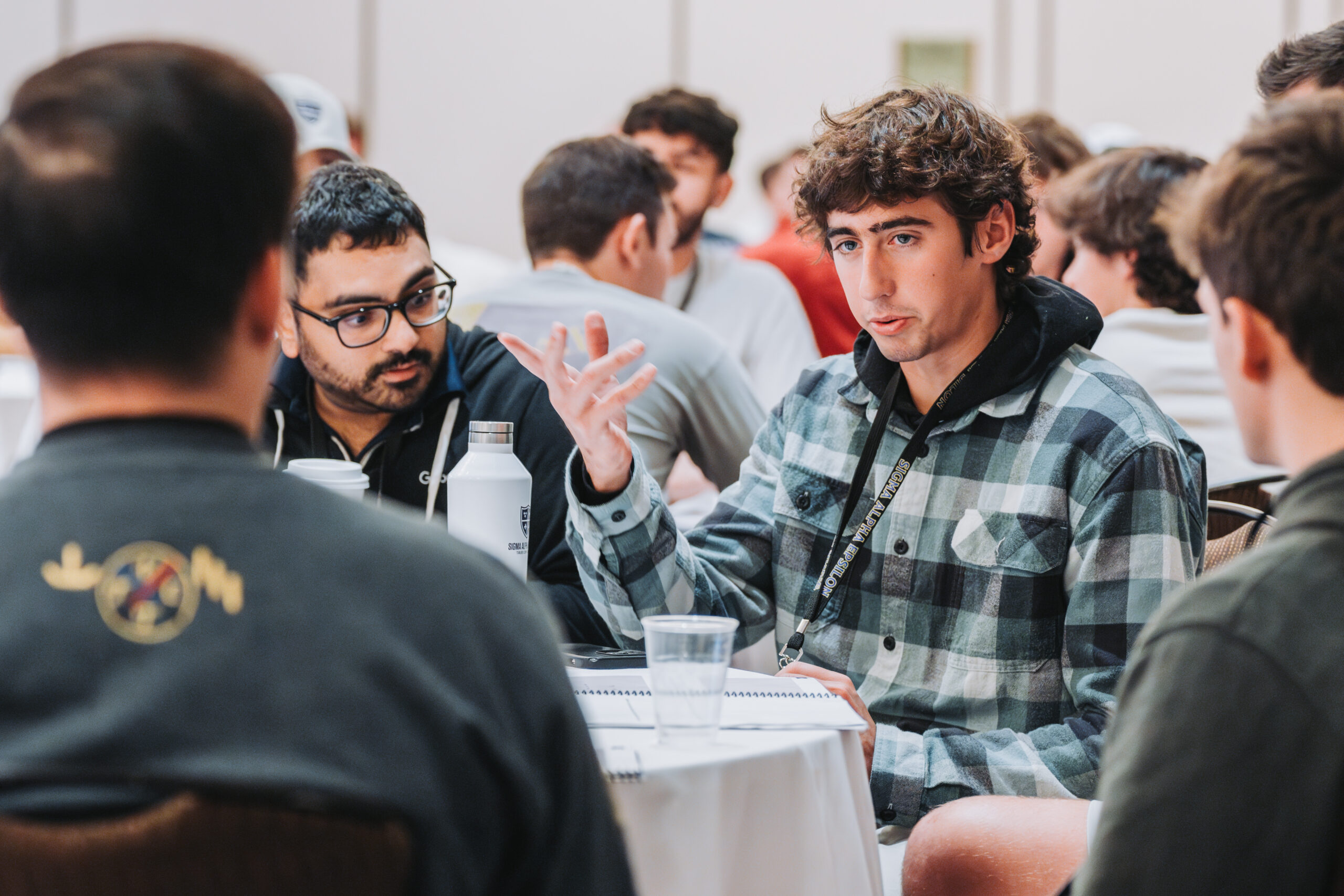 SAE brothers sitting at a conference table at the SAE 85th National Leadership Conference