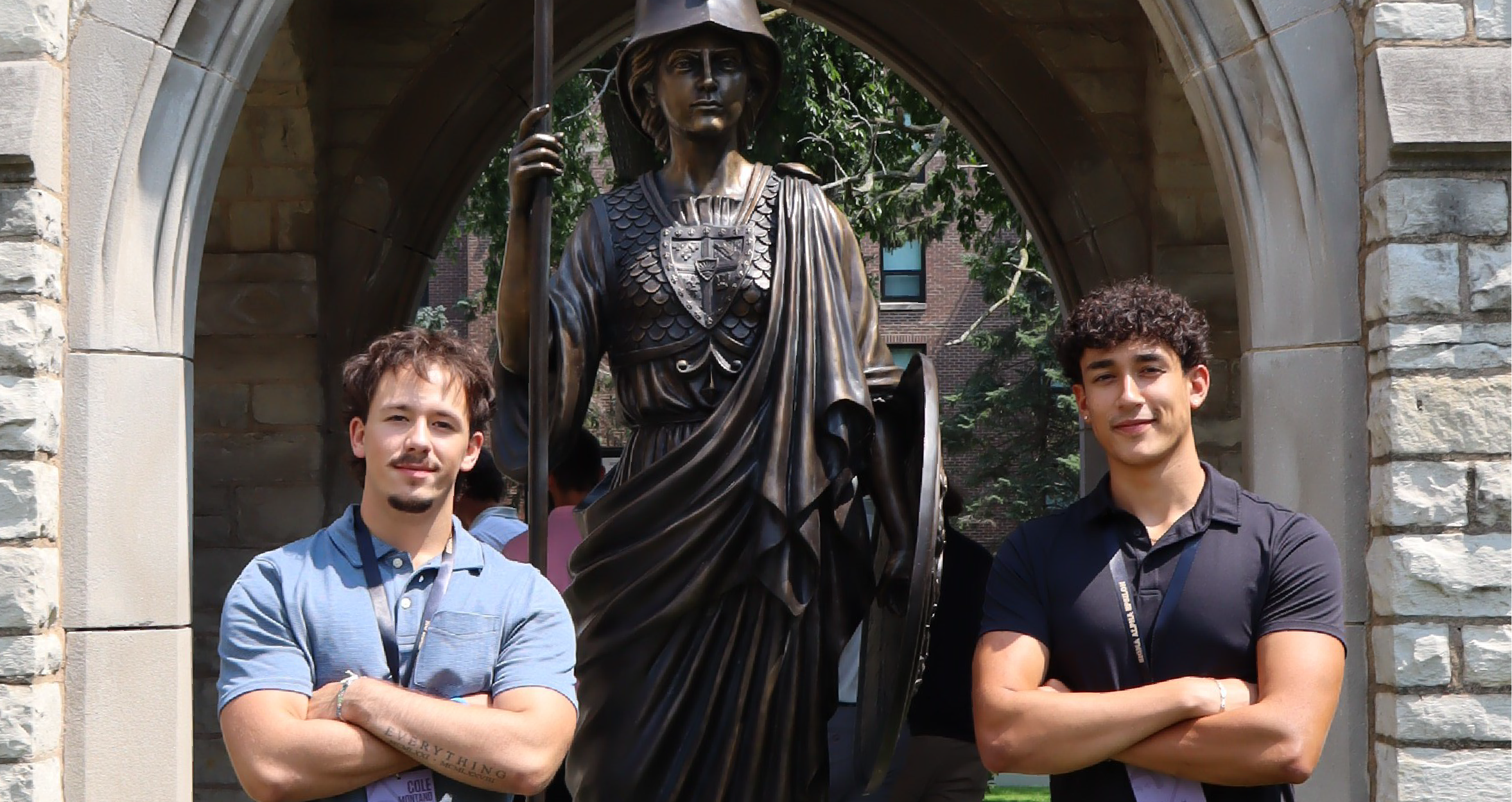 two brothers standing on either side of the Minerva statue